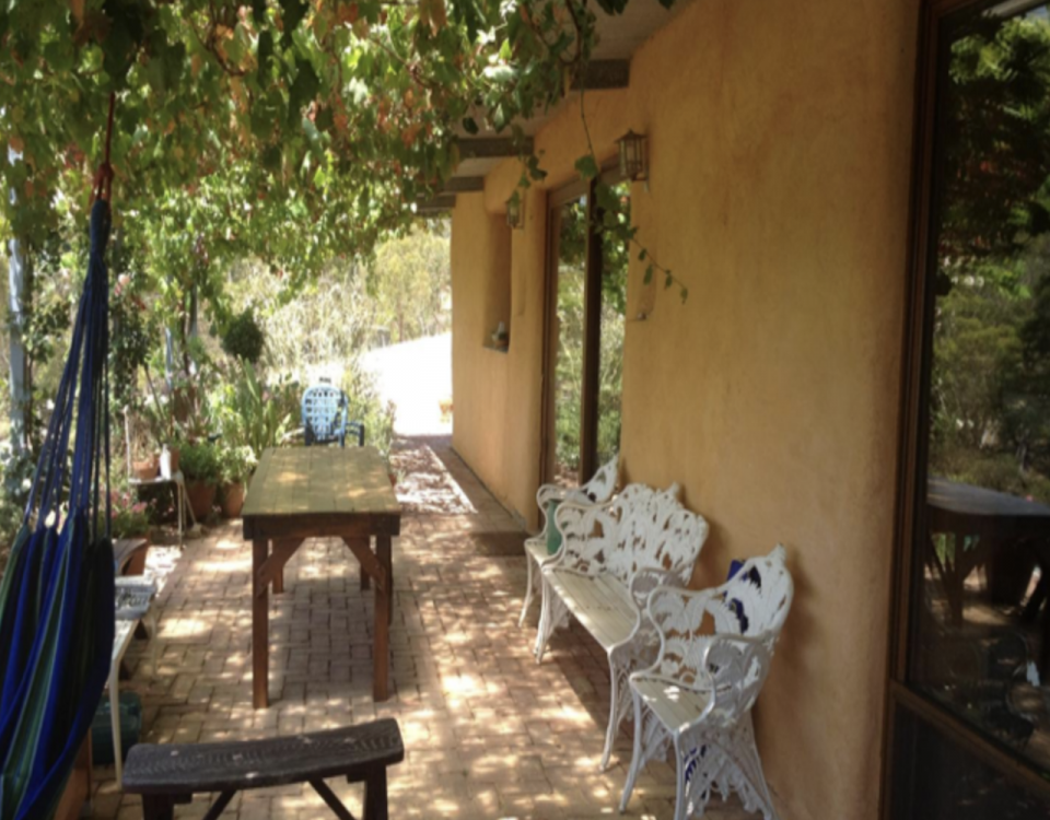 a verandah covering a strawbale and lime rendered wall in South Australia